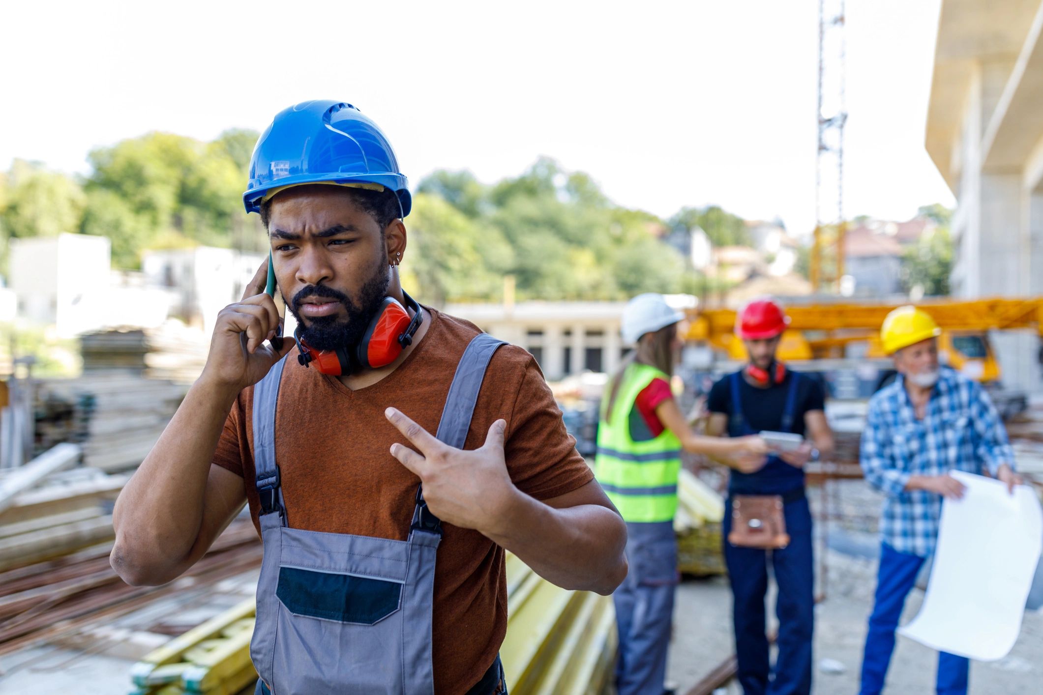 Construction engineer reviewing plans on site